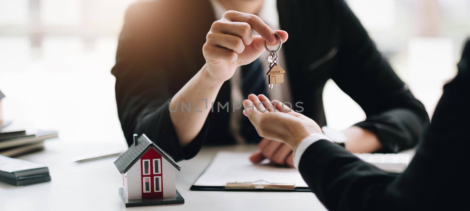 Agents or Dealer delivers keys is the new home to a customer, deal mortgage, making an agreement contract residence, real estate developer. by wichayada