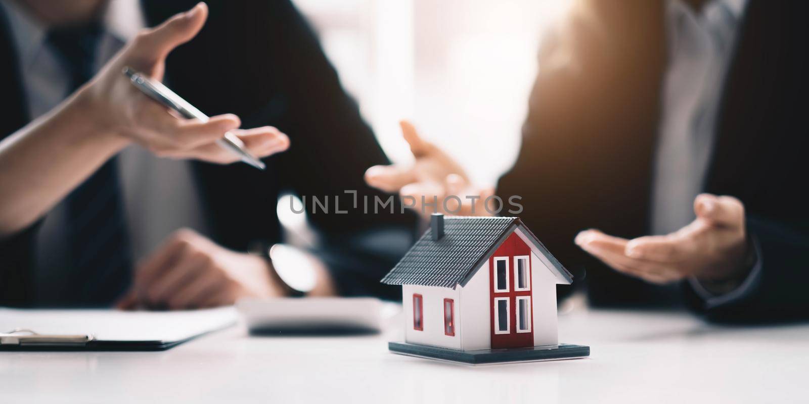 Real estate broker agent presenting and consult to customer to decision making sign insurance form agreement, buy and sell home model, concerning mortgage loan offer for and house insurance by wichayada
