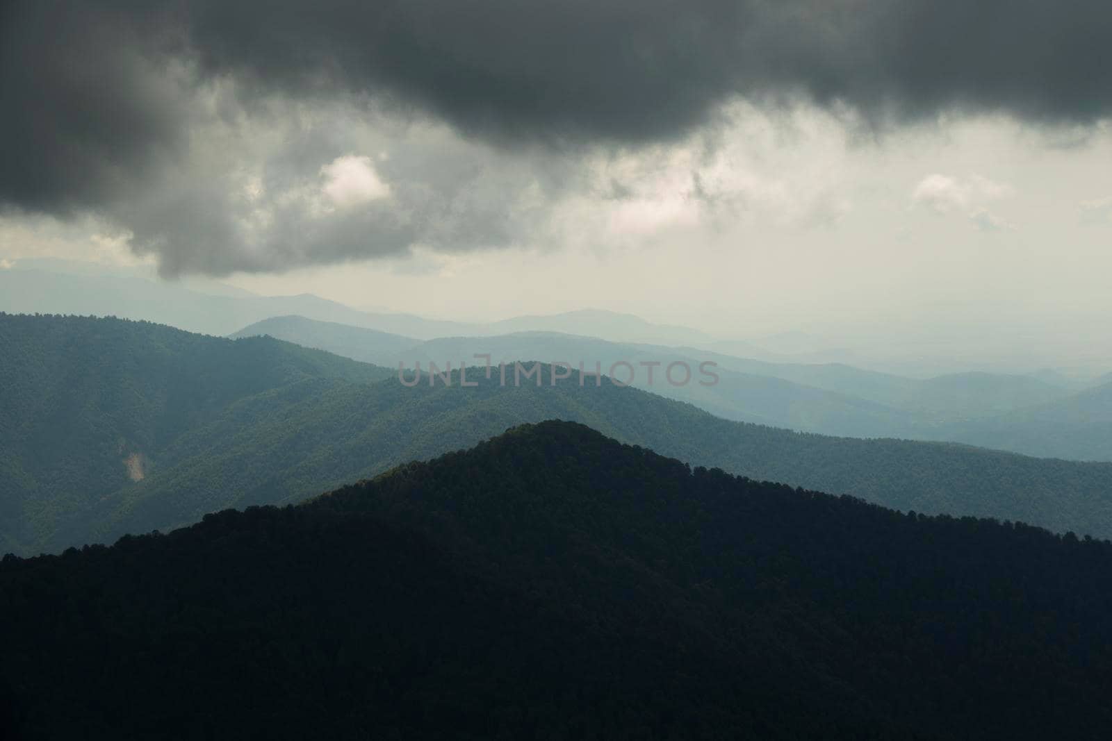 Mountain landscape in Georgia, clouds and blue sky. Mountain range. sunset time.