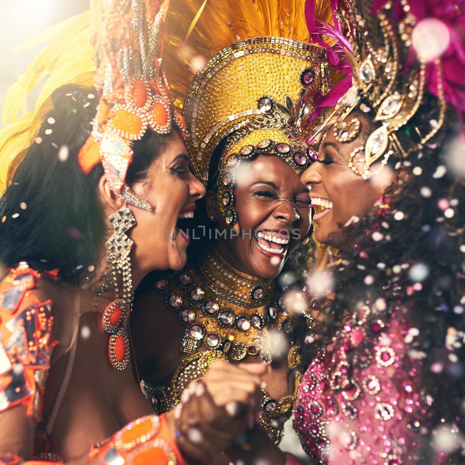 Feeling those Brazilian beats. three beautiful samba dancers performing at Carnival. by YuriArcurs