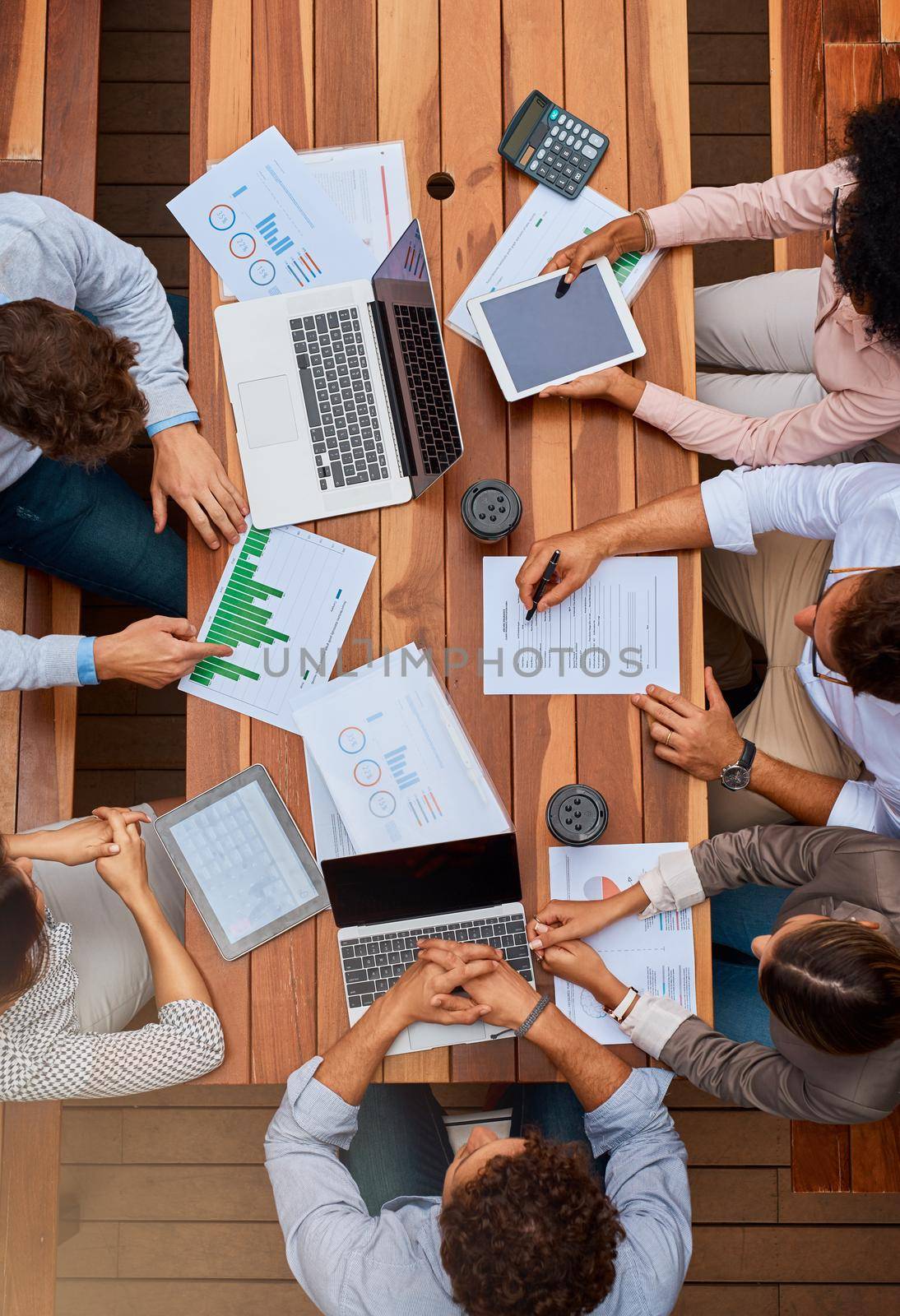Breathing some fresh air into their plans. High angle shot of a group of businesspeople having a meeting outdoors