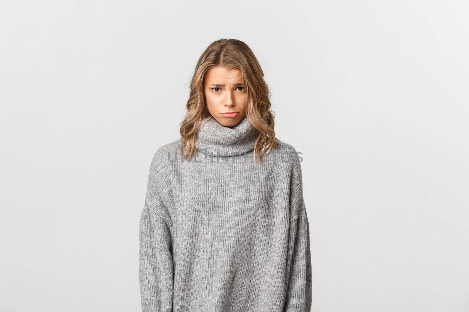 Portrait of cute silly girl frowning, sulking and looking at camera as begging for something, about to cry, standing over white background by Benzoix