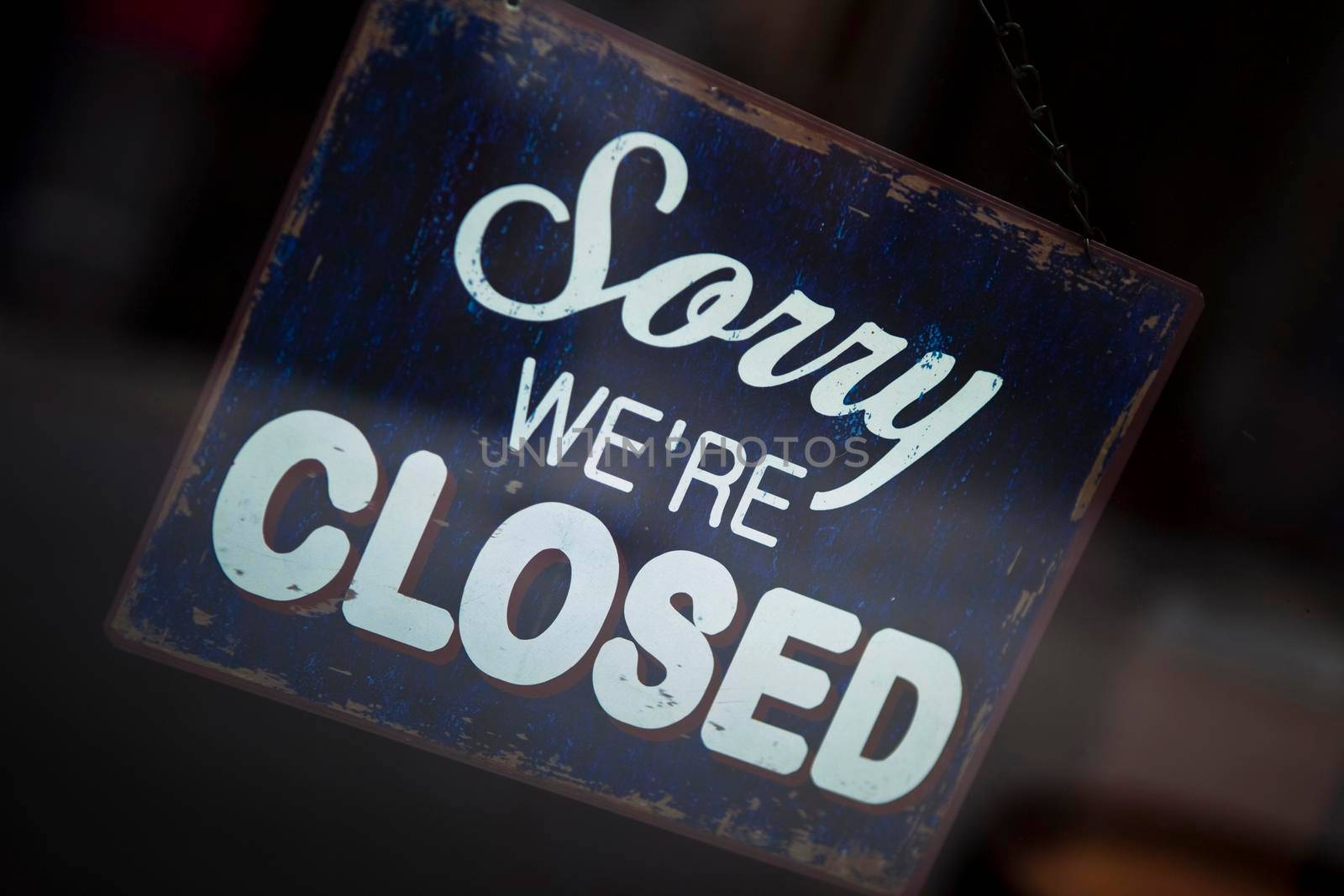Close up of a vintage closed sign on a shop window