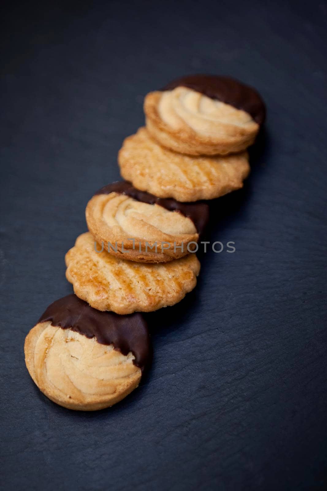 Crispy cookies and chocolate on slate on a table