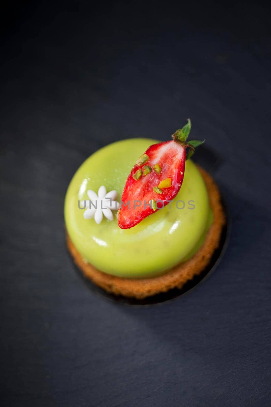 Pistachio mousse and strawberry on a biscuit