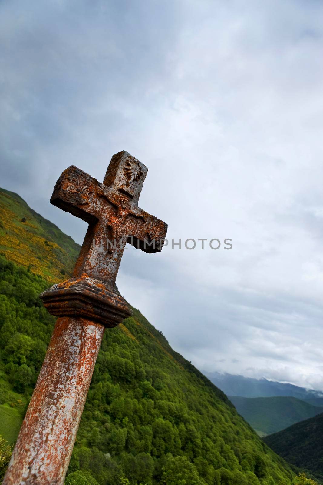 Old stone cross in the mountains of the Pyrenees in France
