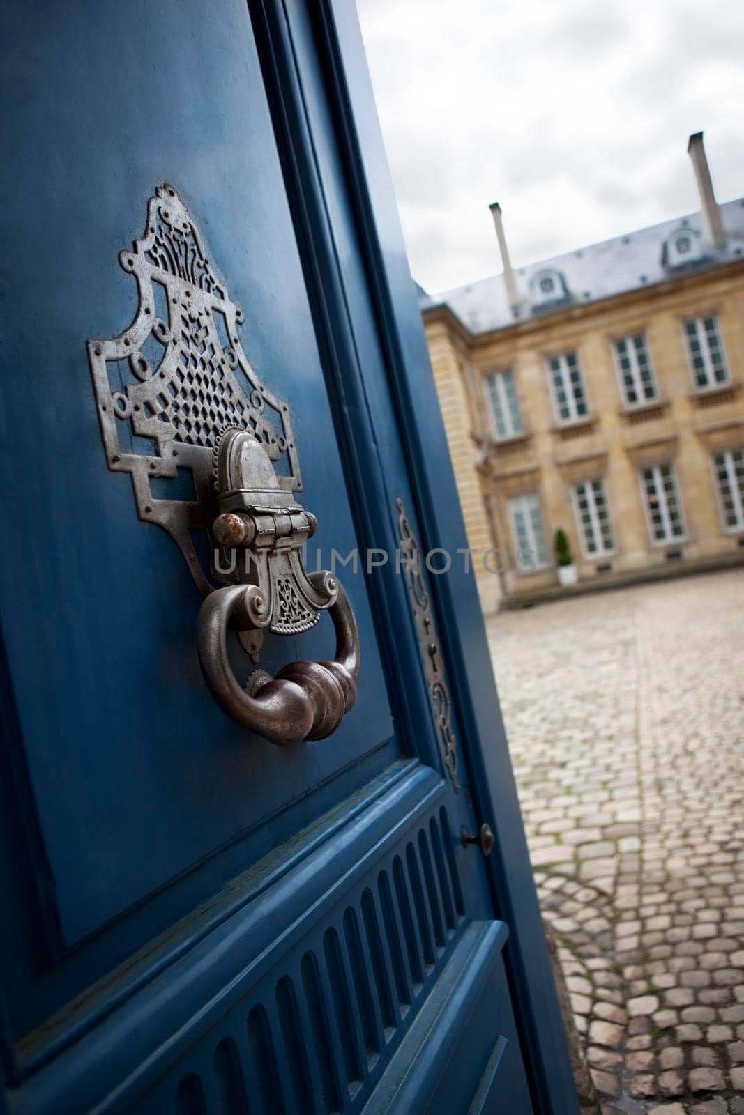 Detail of a bronze knocker on the door of a French mansion in Bordeaux
