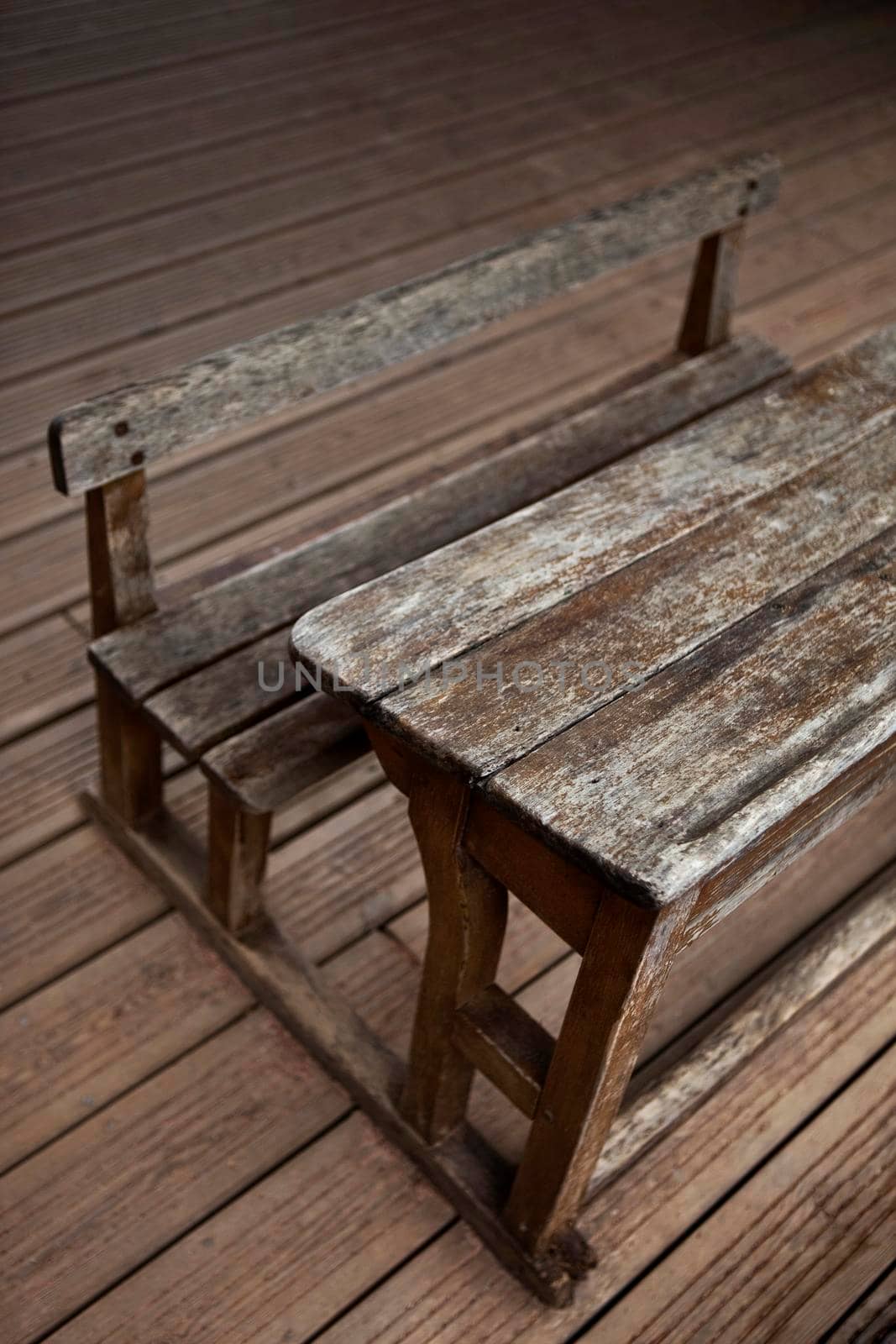 Vintage old wooden desk on floor in a classroom