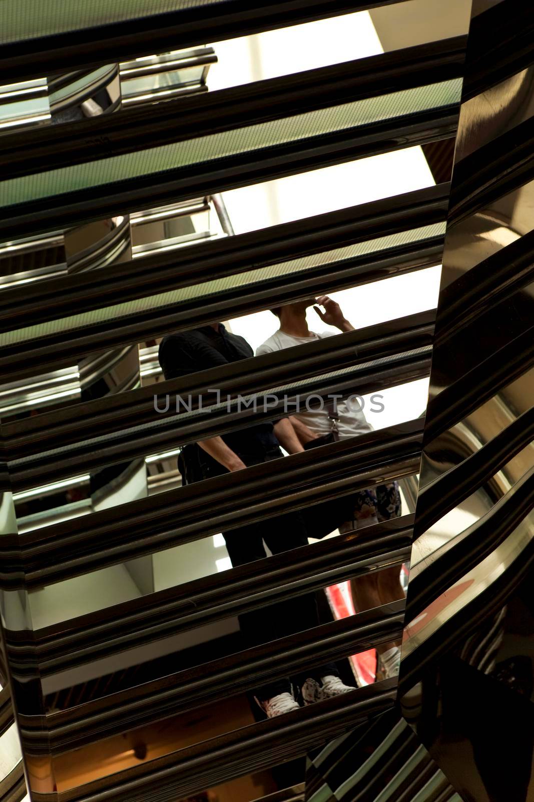 Two people waiting on the steps of a staircase