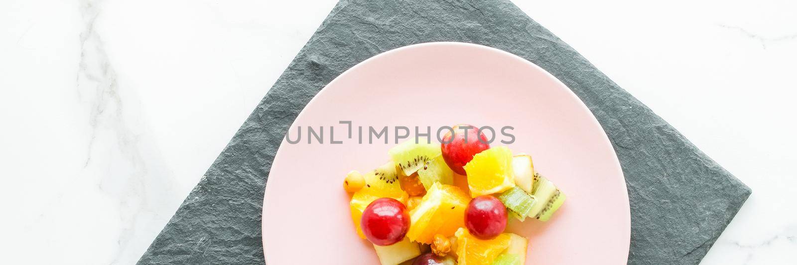 juicy fruit salad for breakfast on marble, flatlay - dieting and healthy lifestyle styled concept