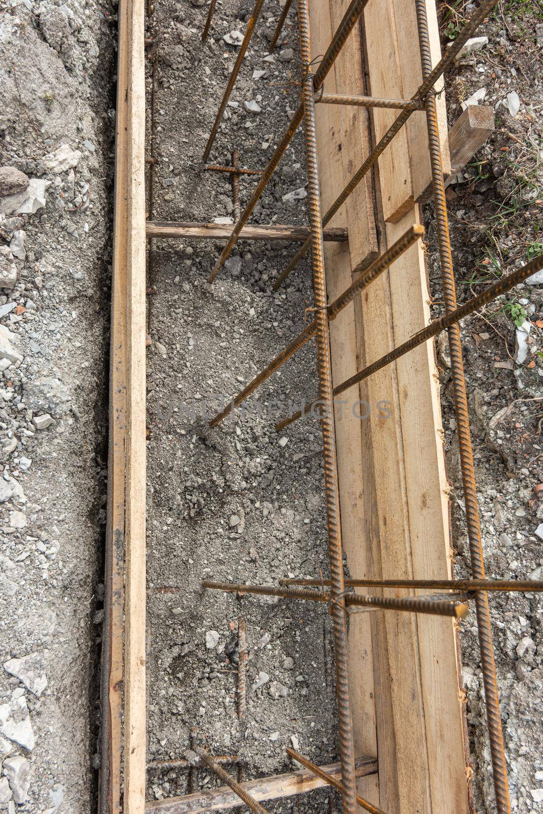 Partially buried bonded reinforcement and strip foundation formwork by Madhourse