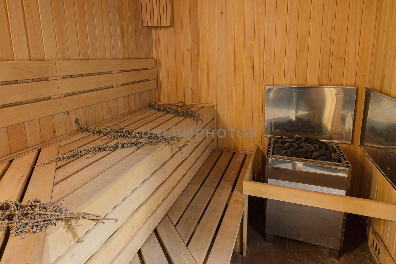 Interior of a sauna in a private house with an electric boiler