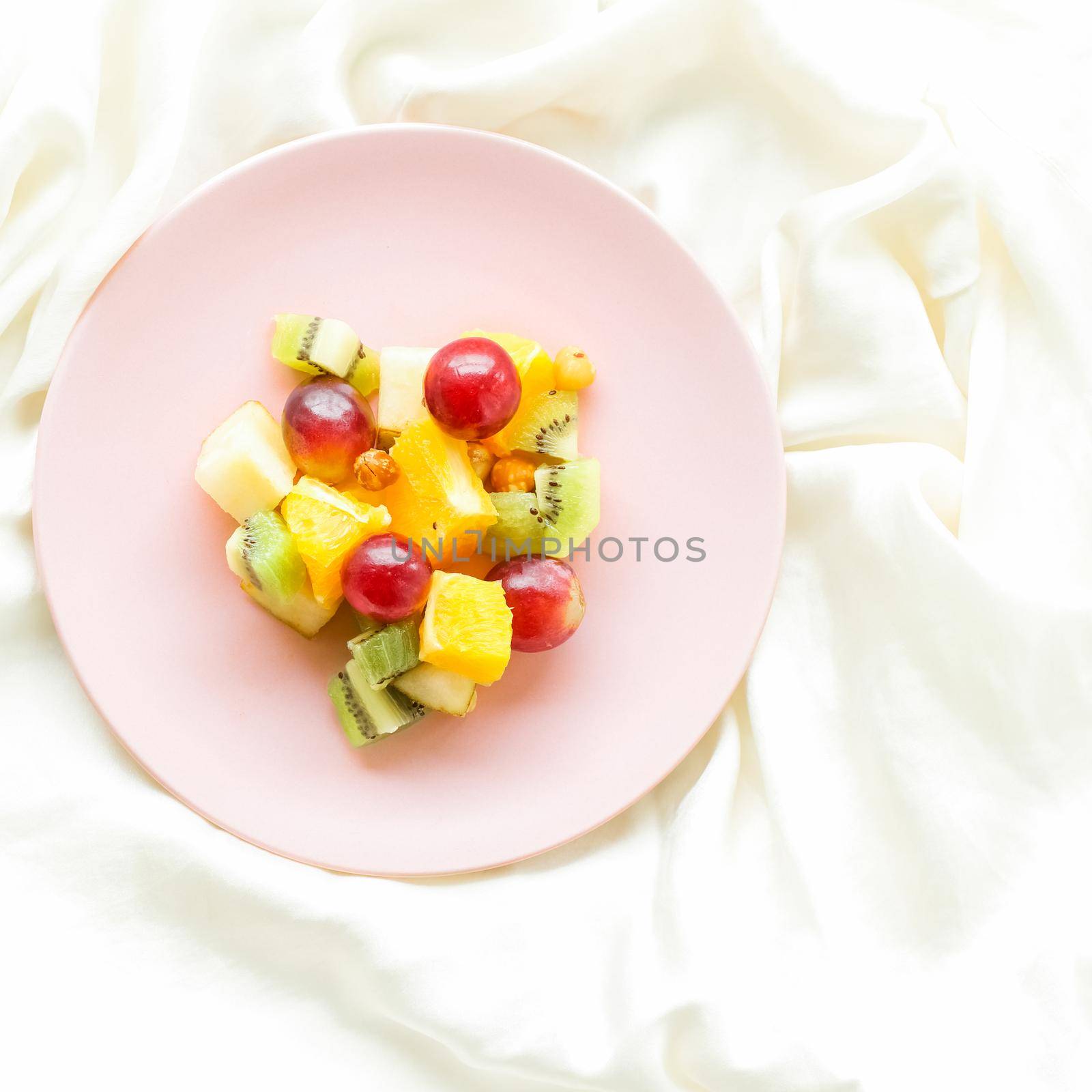 juicy fruit salad on silk, flatlay - healthy lifestyle and breakfast in bed concept by Anneleven