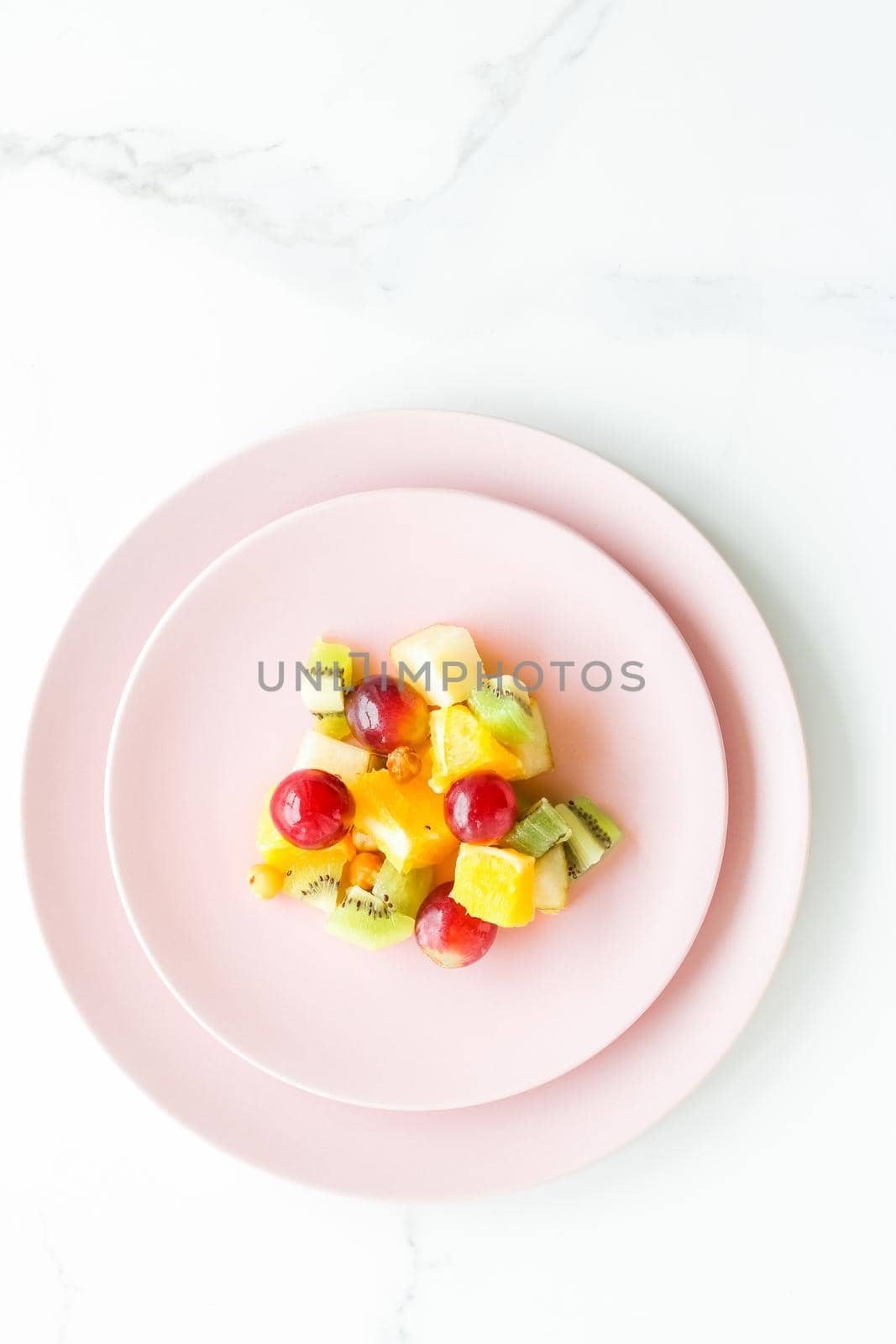 juicy fruit salad for breakfast on marble, flatlay - dieting and healthy lifestyle concept by Anneleven