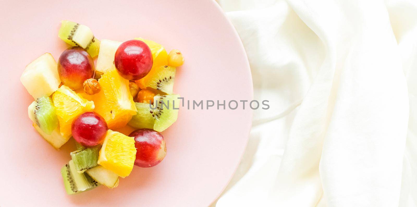 juicy fruit salad on silk, flatlay - healthy lifestyle and breakfast in bed concept by Anneleven