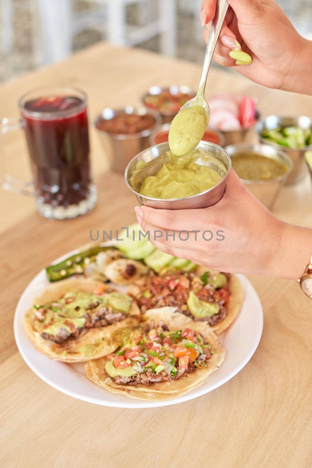 Girl adding salsa to her delicious tacos by JpRamos