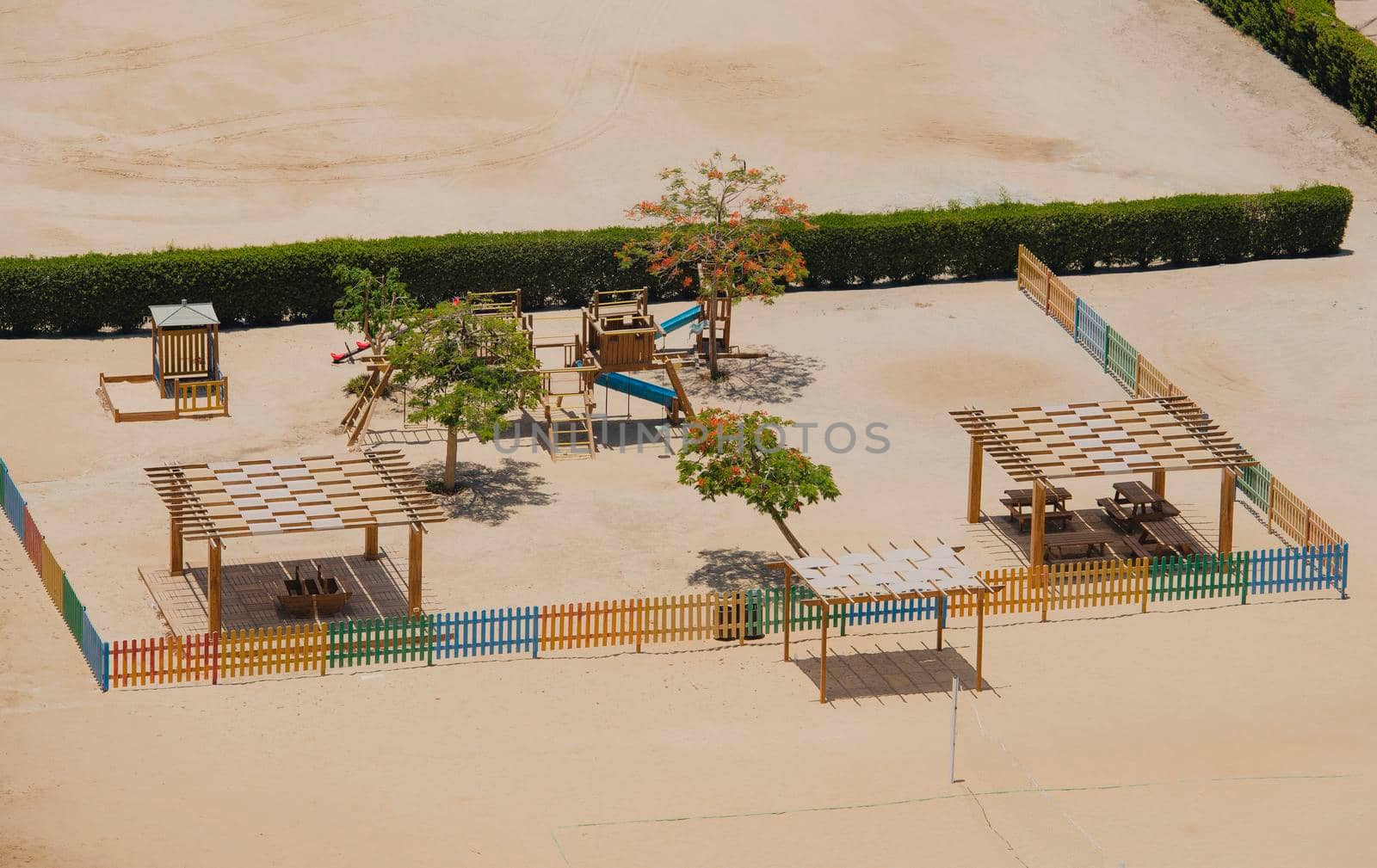 Aerial view of childrens playground area in tropical hotel by paulvinten