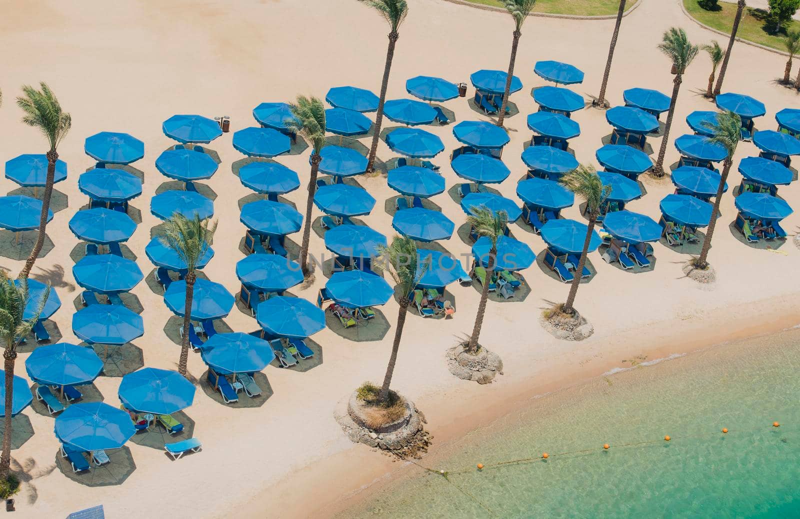 Aerial view over tropical luxury hotel beach by paulvinten