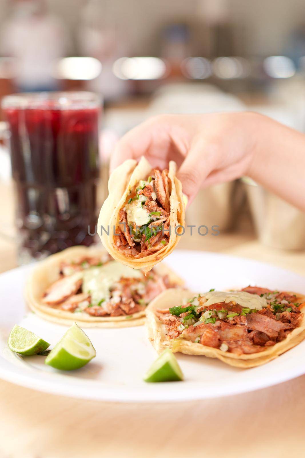 Girl eating delicious taco with salsa and a variety of toppings by JpRamos