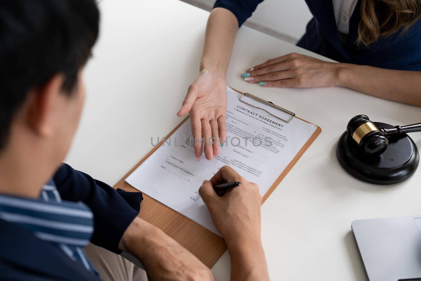 Business people negotiating a contract. Human hands working with documents at desk and signing contract