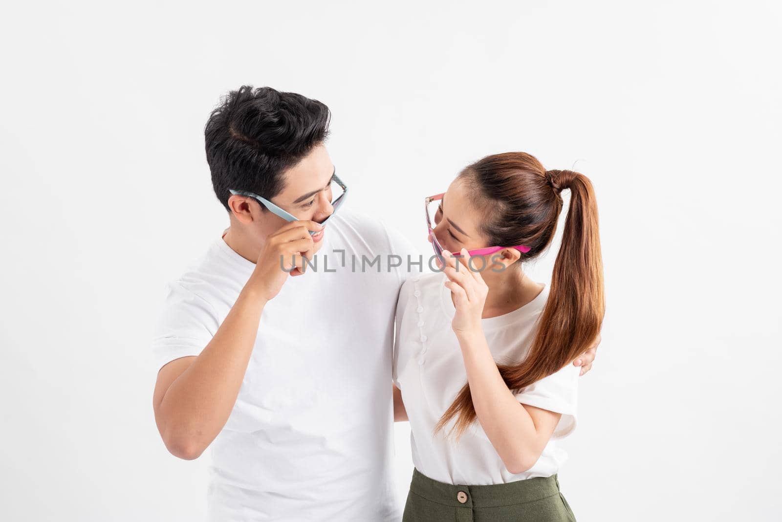 Young cheerful couple in love with glasses huging each other