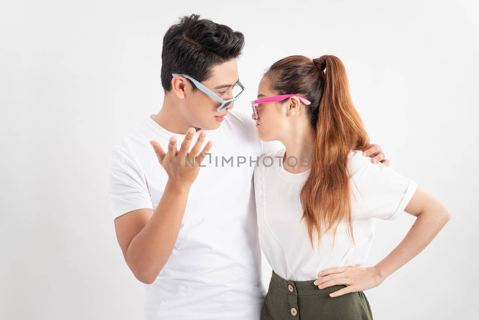 summer accessory, eyewear and people concept - portrait of happy couple in white t-shirts and sunglasses over white background