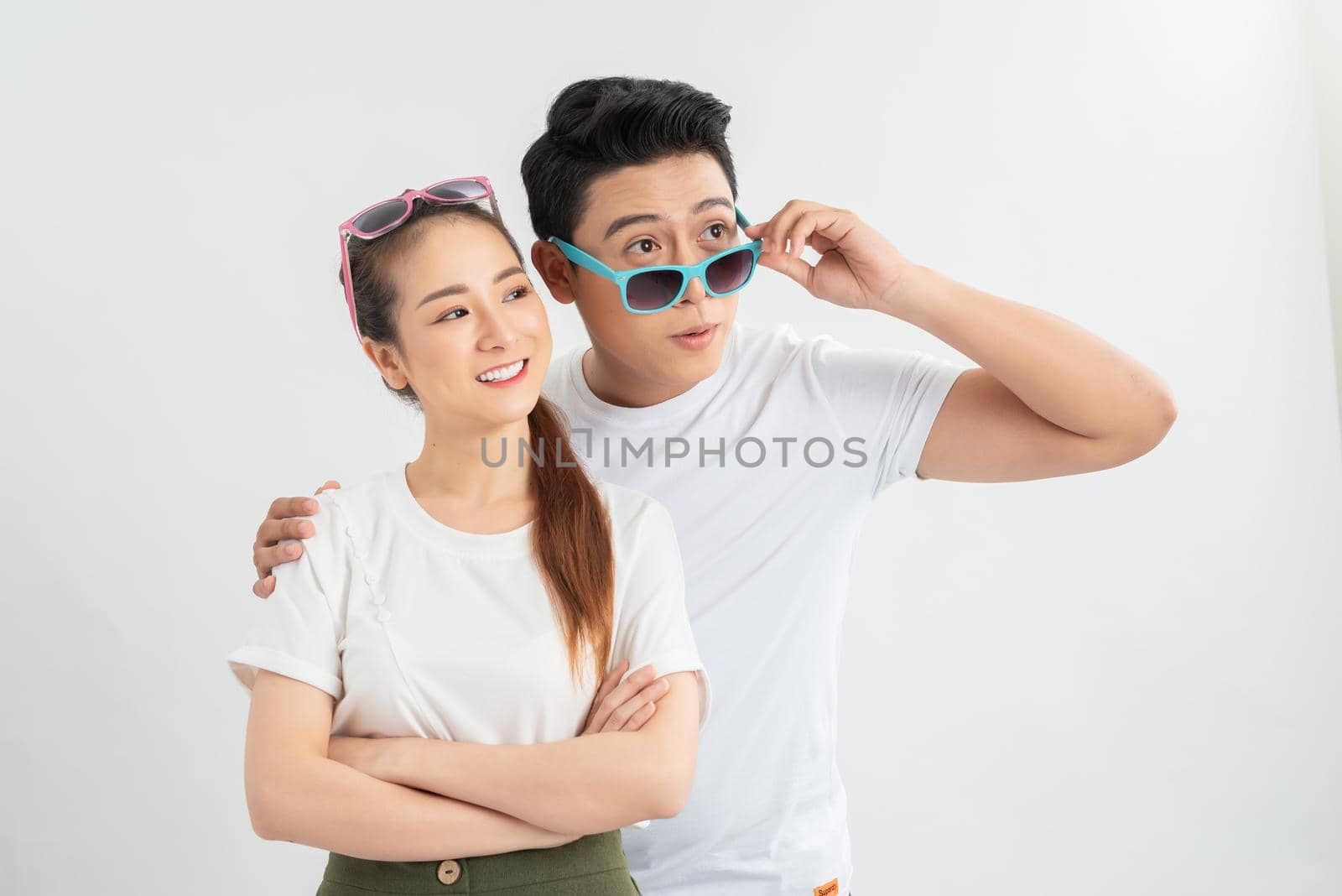 Shocked young friends or family couple dropping eyeglasses, feeling amazed head shot portrait