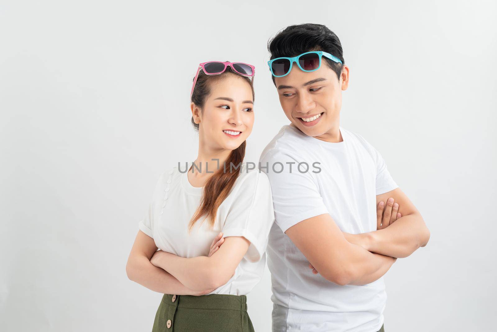 Cheerful hsppy man and woman with crossed hands standing back to back. by makidotvn
