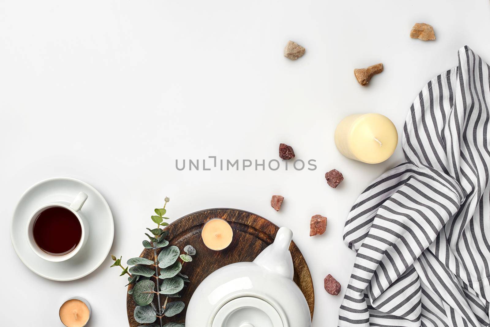 Still life with tea cup and the contents of a workspace composed. Different objects on white table. Flat lay. Top view. Copy space