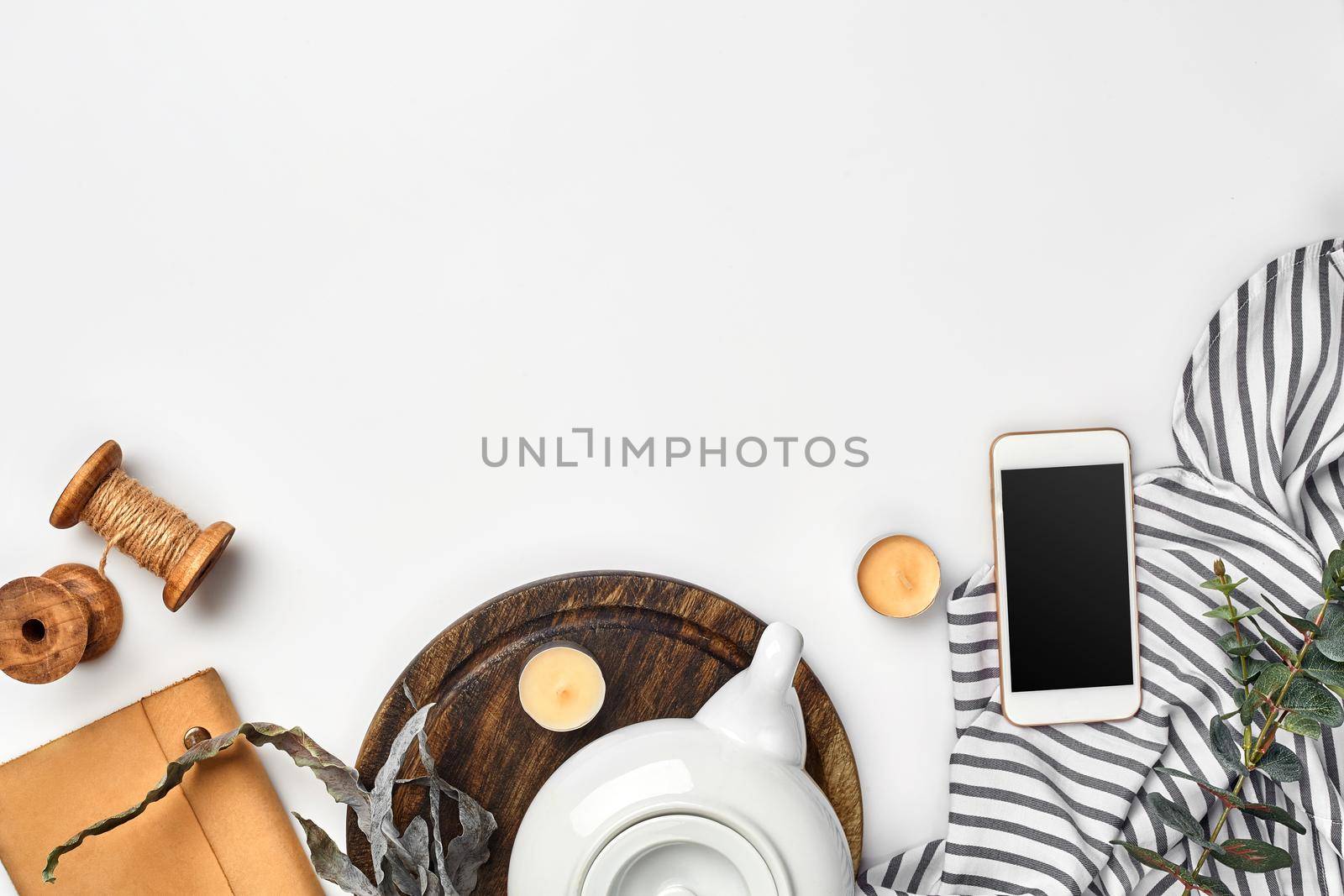 Still life with tea cup and the contents of a workspace composed. Different objects on white table. Flat lay by nazarovsergey