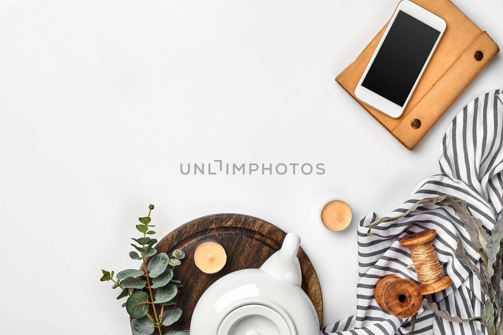 Still life with tea cup and the contents of a workspace composed. Different objects on white table. Flat lay. Top view. Copy space