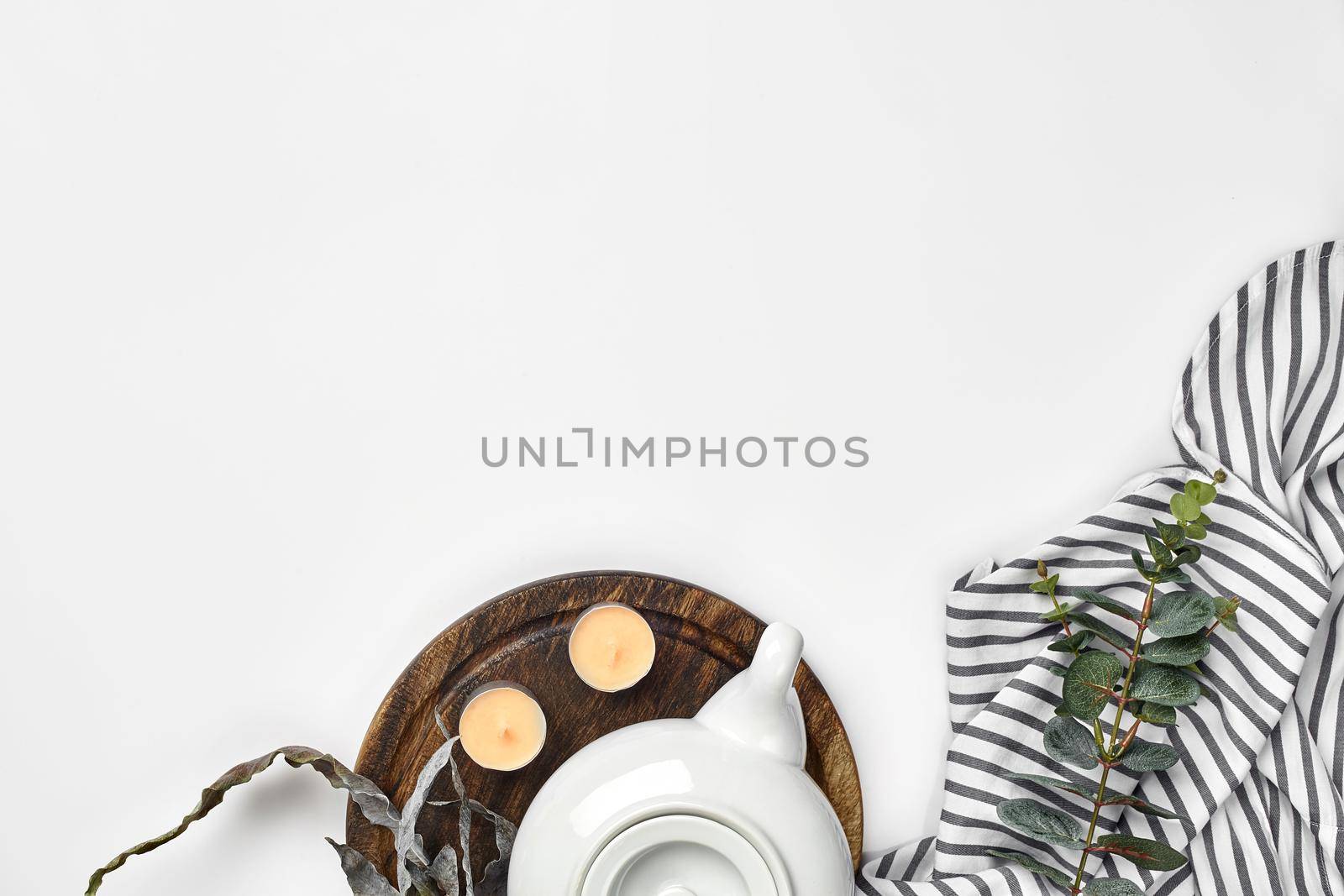 Still life with tea cup and the contents of a workspace composed. Different objects on white table. Flat lay. Top view. Copy space