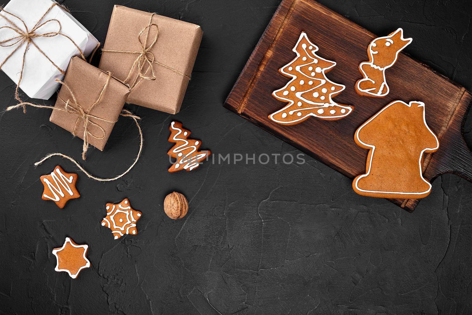 Christmas composition. Xmas cookies, gifts, festive decoration on black background. Flat lay, top view, with copy space. Close Up