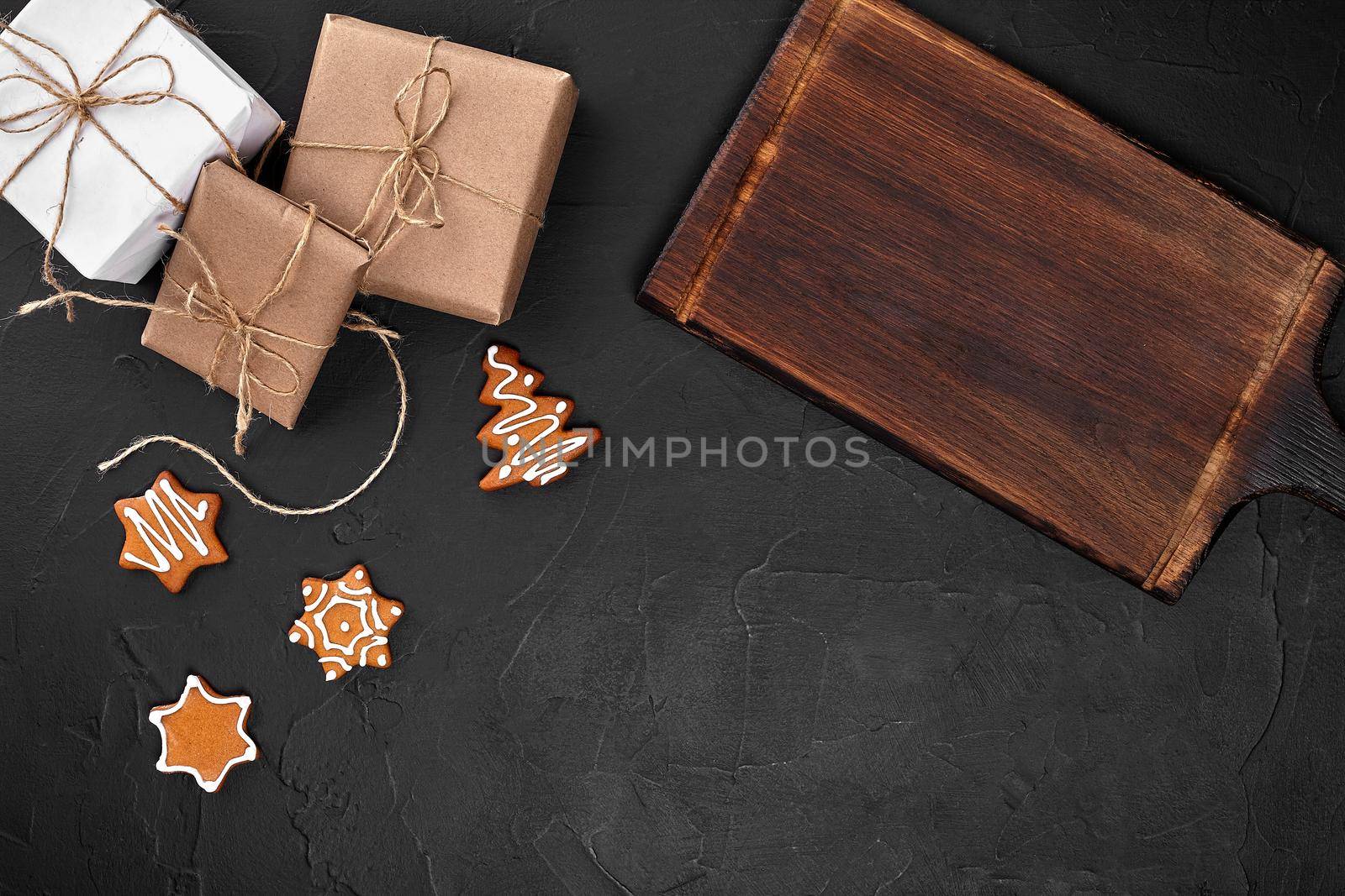 Christmas composition. Xmas cookies, gifts, festive decoration on black background. Flat lay, top view, with copy space. Close Up