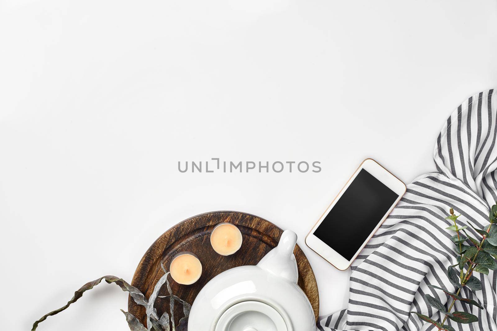 Still life with tea cup and the contents of a workspace composed. Different objects on white table. Flat lay. Top view. Copy space