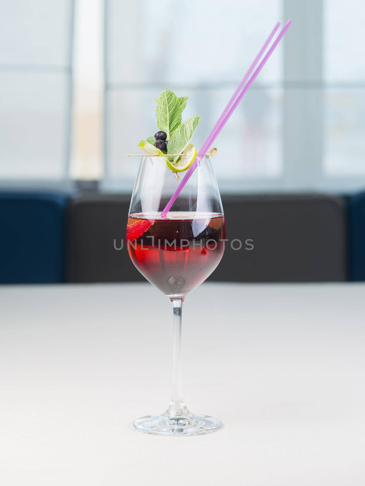 Colorful bright cocktail in wine high glass. Cooling drink. Fresh beverage