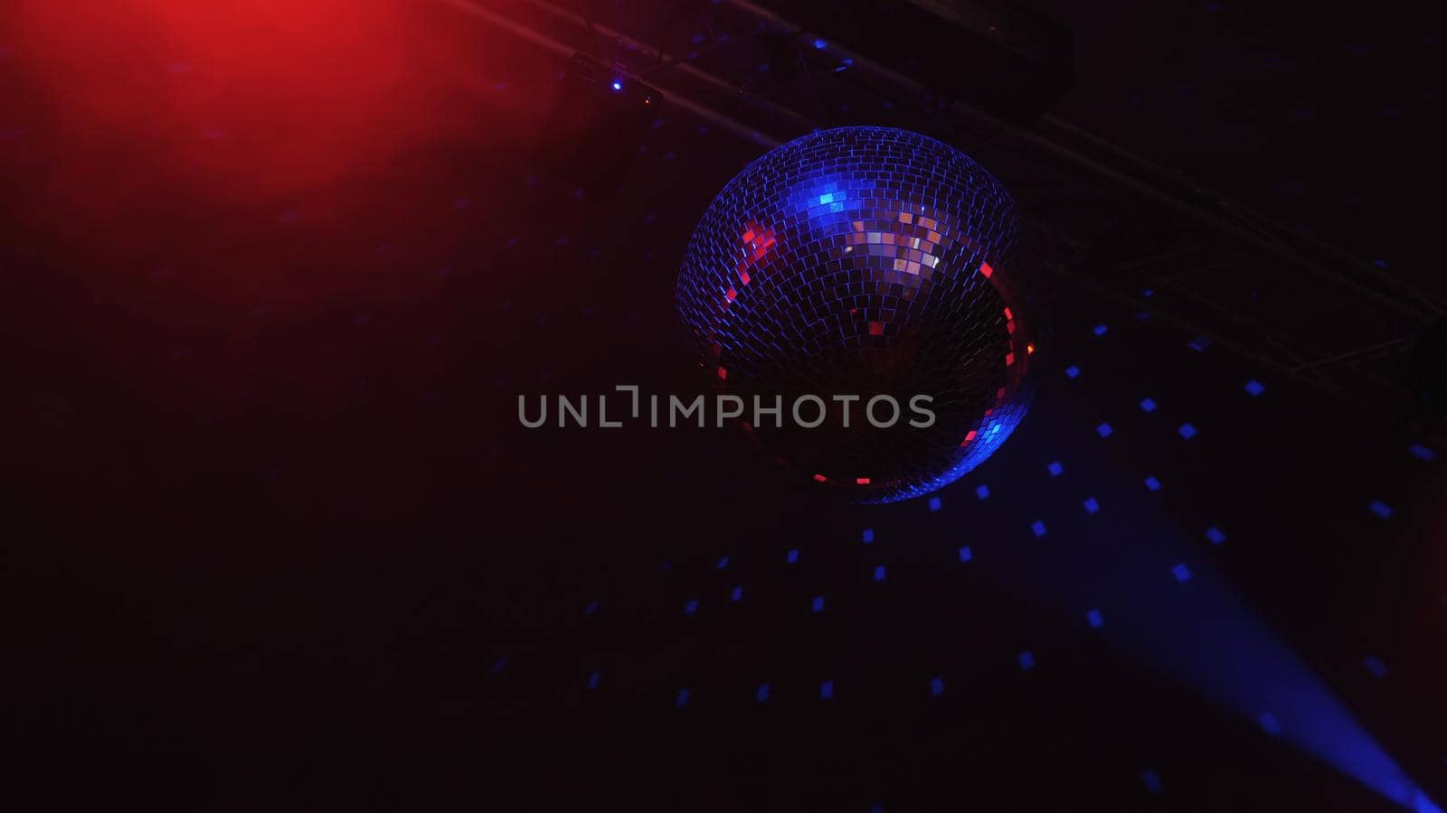 Beautiful Disco Ball Spinning seamless with flares. Mirror ball with bright rays, night party background footage.