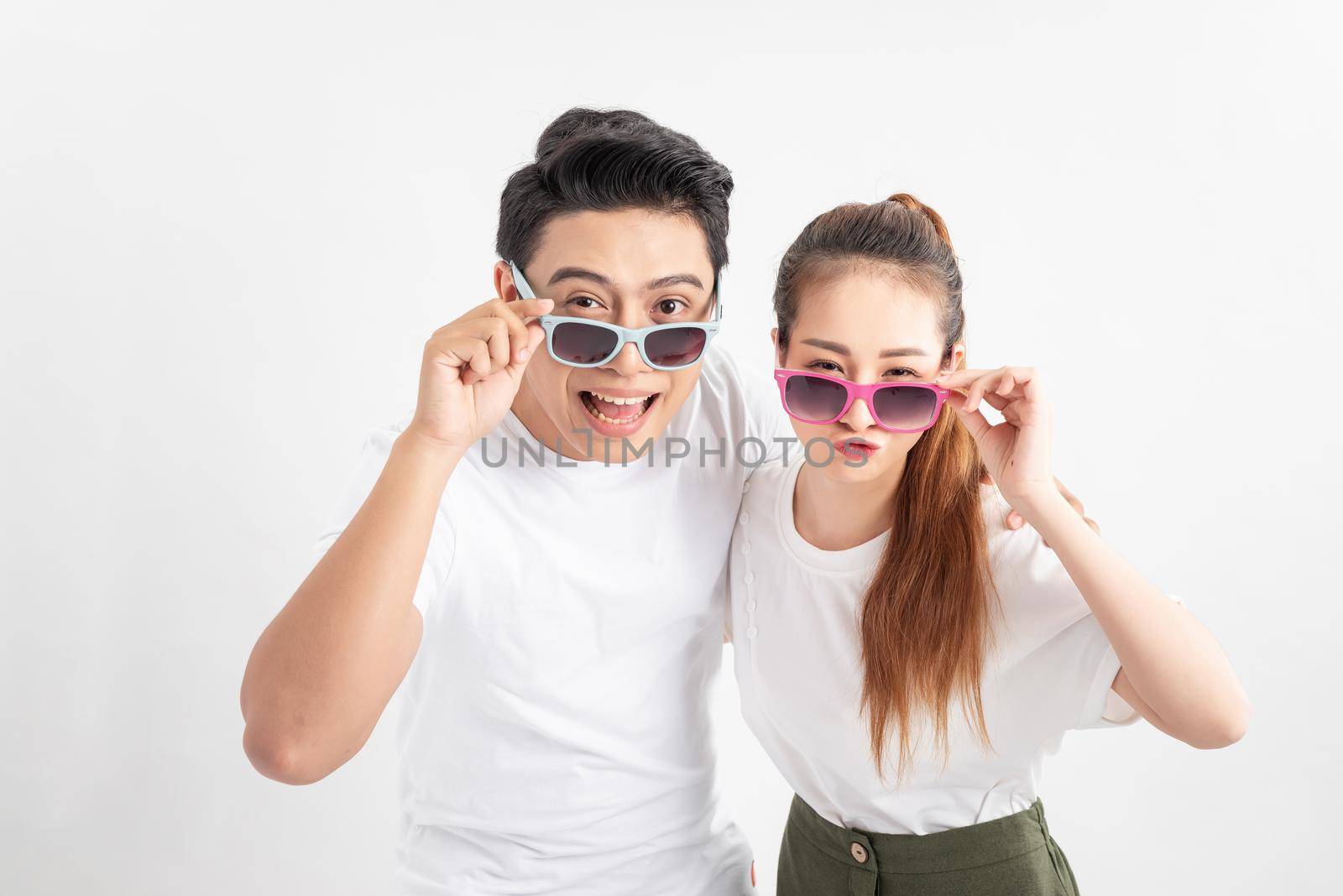 Close up photo of astonished spouses touching their eyewear eyeglasses wearing glasses eyewear isolated over white background by makidotvn