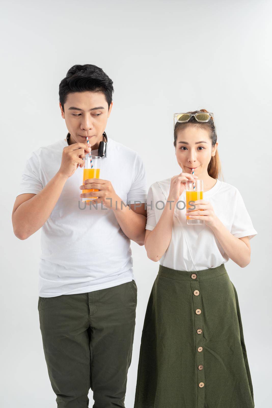 a happy couple is enjoying some drinks together