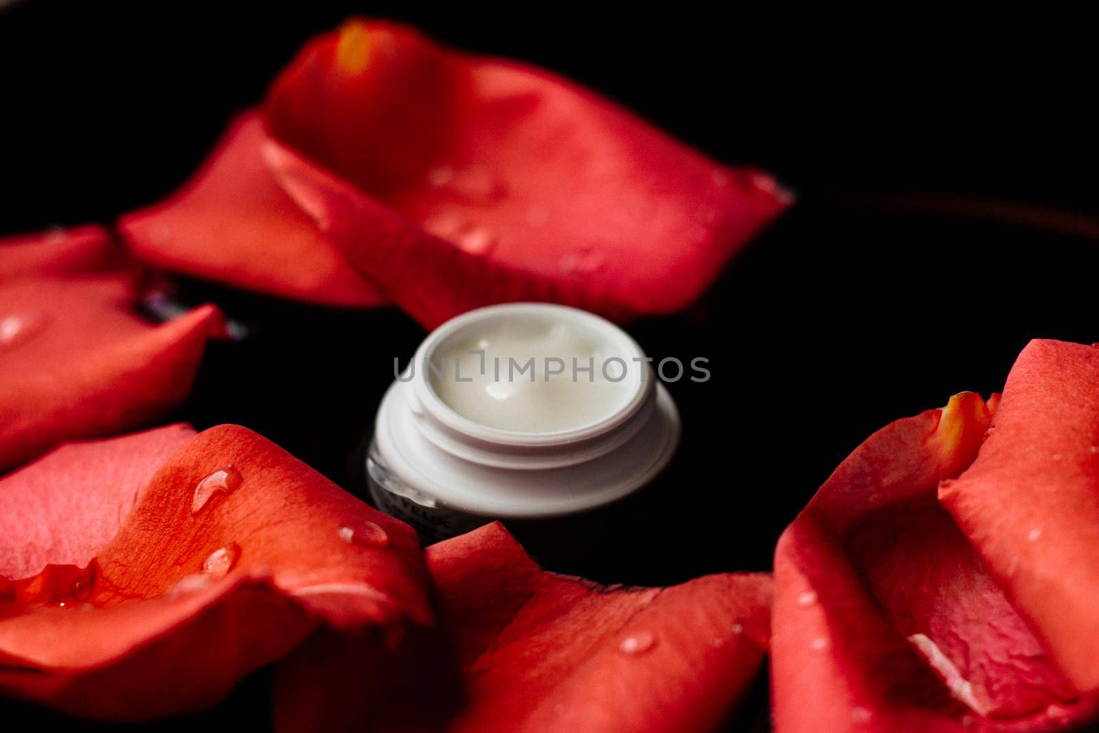 beauty cream jar and flower petals - cosmetics with flowers styled concept by Anneleven