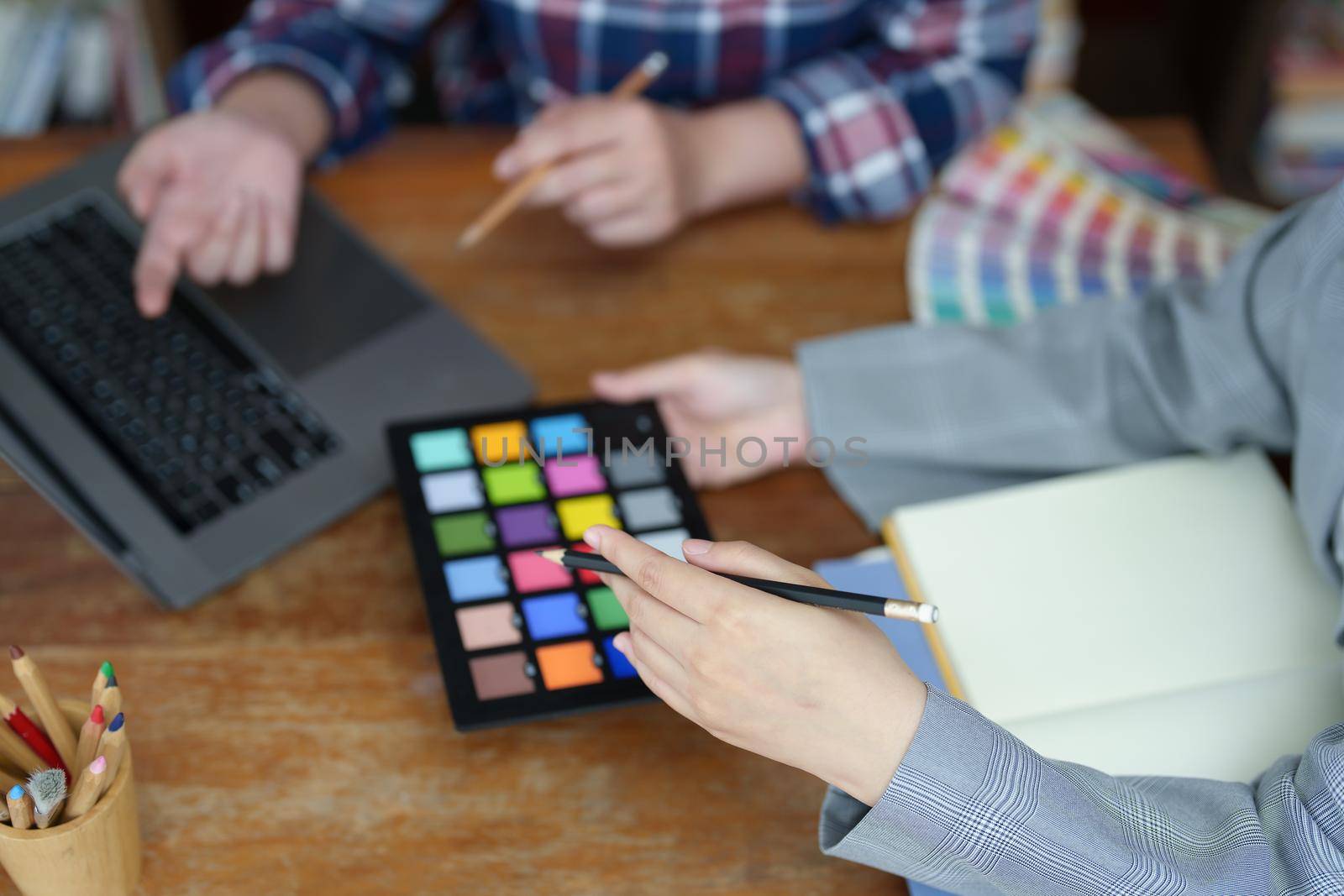 A group of professional web developer and graphic designer working together in the office.