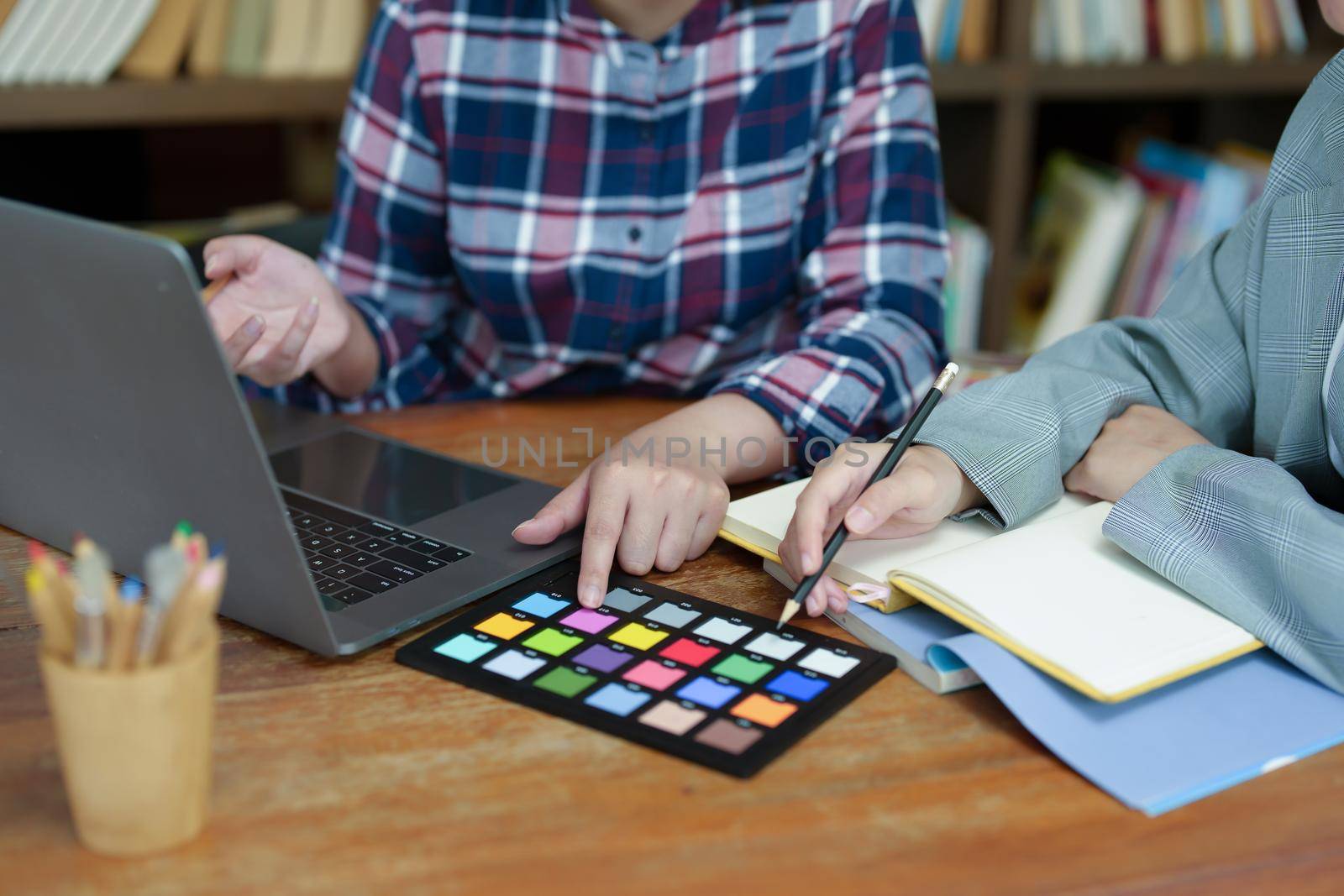 A group of professional web developer and graphic designer working together in the office.