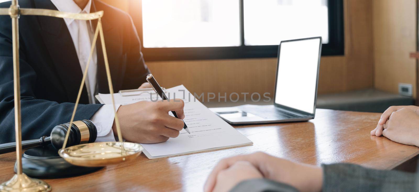 Business woman and lawyers discussing contract papers with brass scale on wooden desk in office. Law, legal services, advice, Justice concept..