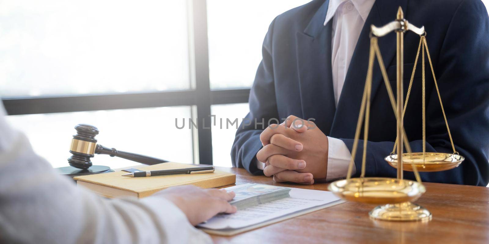 Business woman giving bribe money the form of dollar bills to mature counselor while give success the deal to finishing contract agreement, Bribery and corruption concept by wichayada