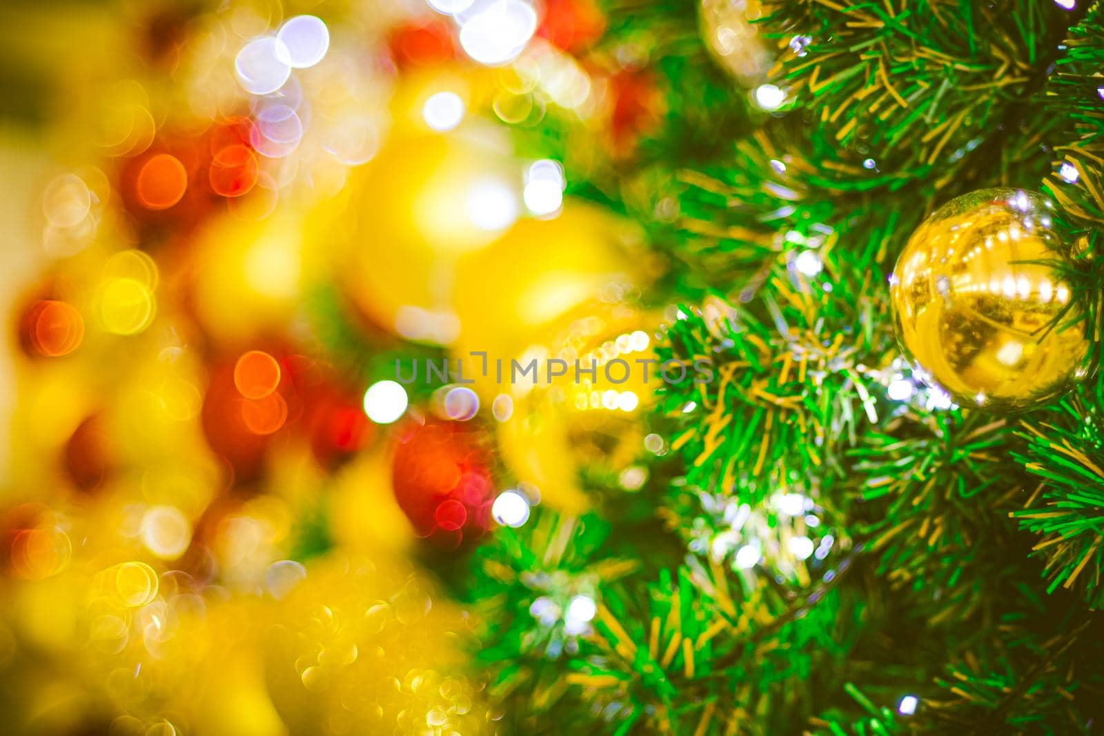 Christmas ball decoration on yellow background. Colorful blur bokeh background. christmas background by Petrichor