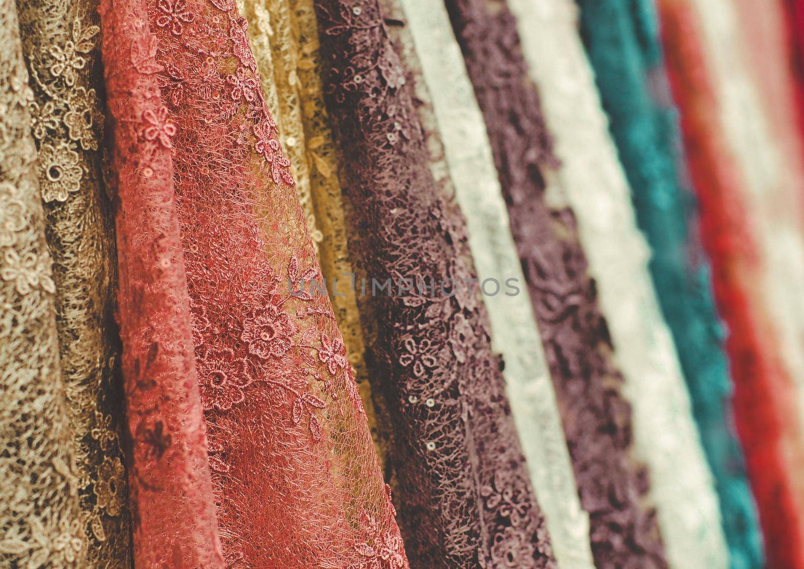 colorful  lace fabric  rolls incolorful lace cloth fabric rolls in textile shop industry textile shop industry by Petrichor