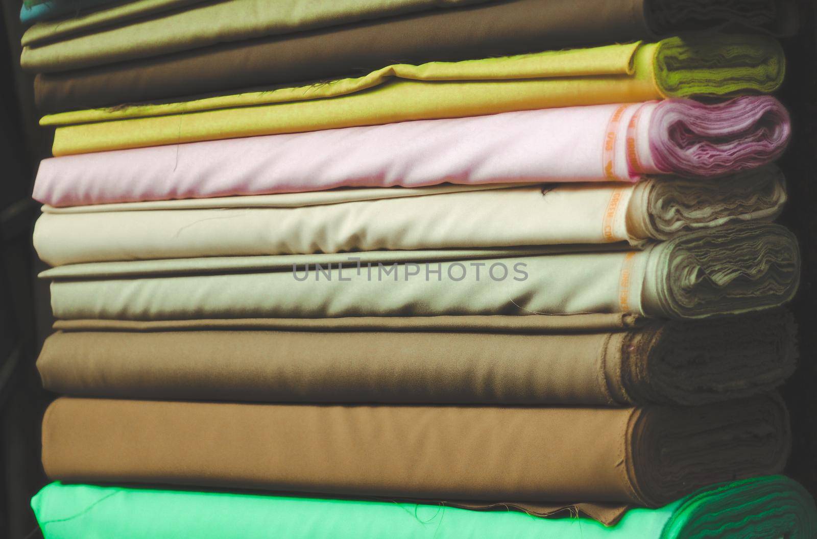 colorful fabric cotton rolls in textile shop industry manufacture material. by Petrichor