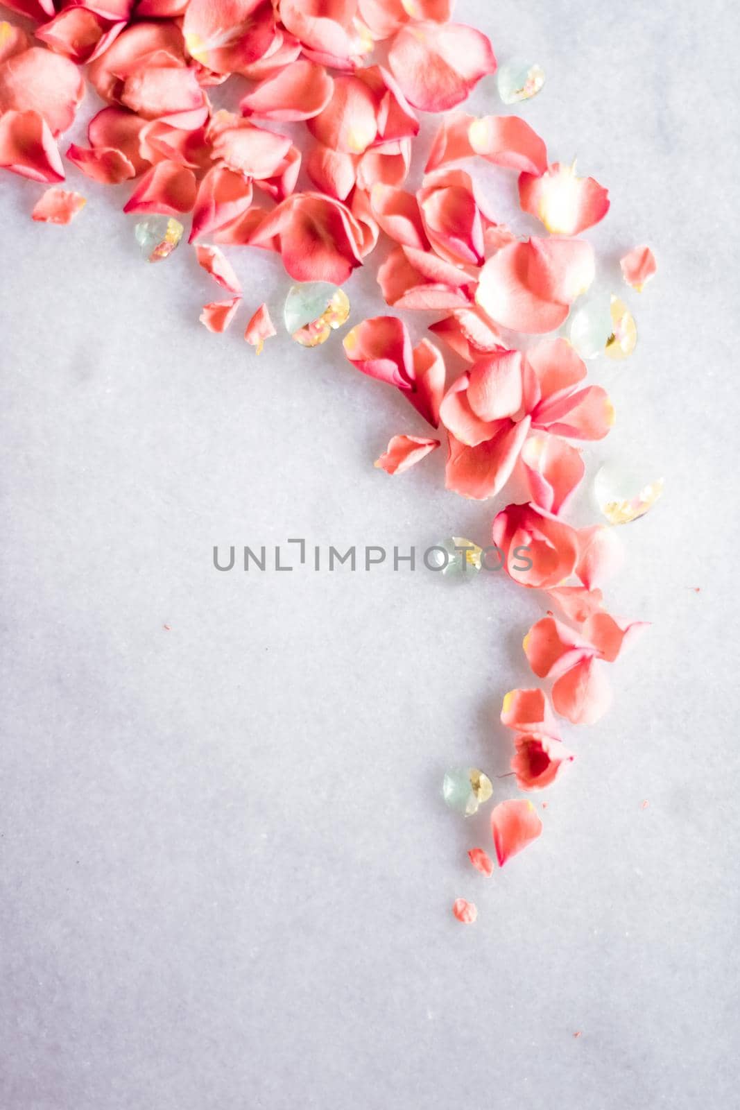 coral rose petals on marble, color of the year - flower backgrounds and holidays concept by Anneleven