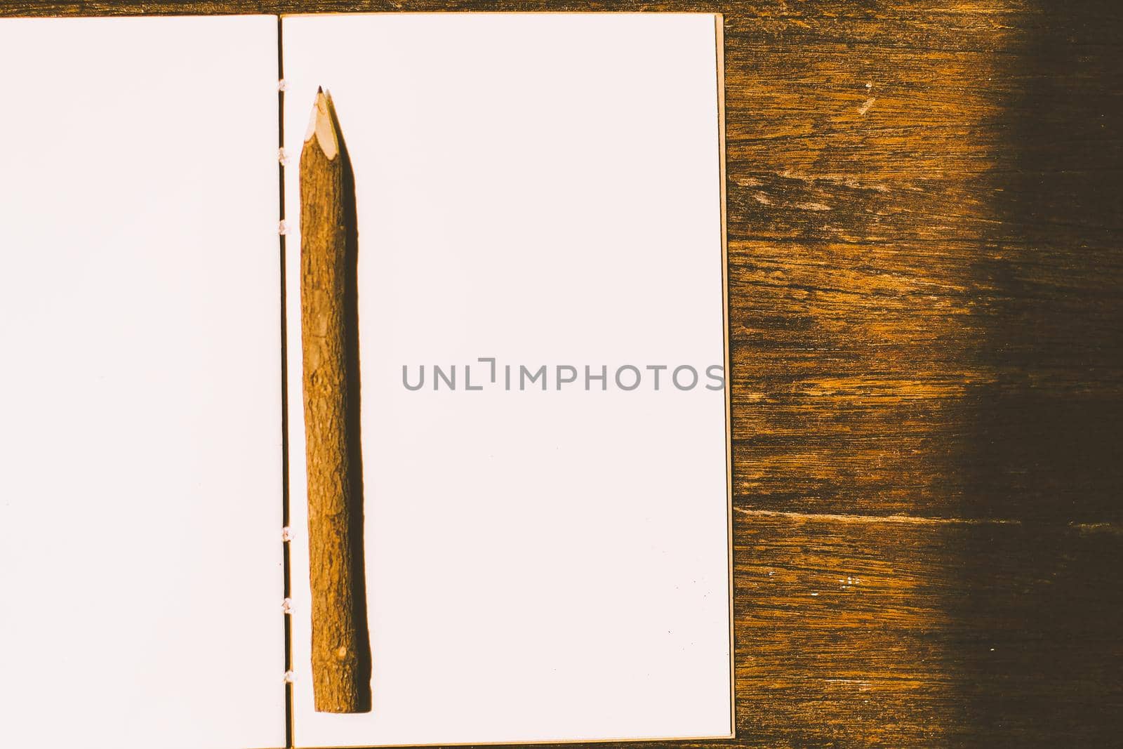a pencil on a clean piece of white paper notebook. by Petrichor