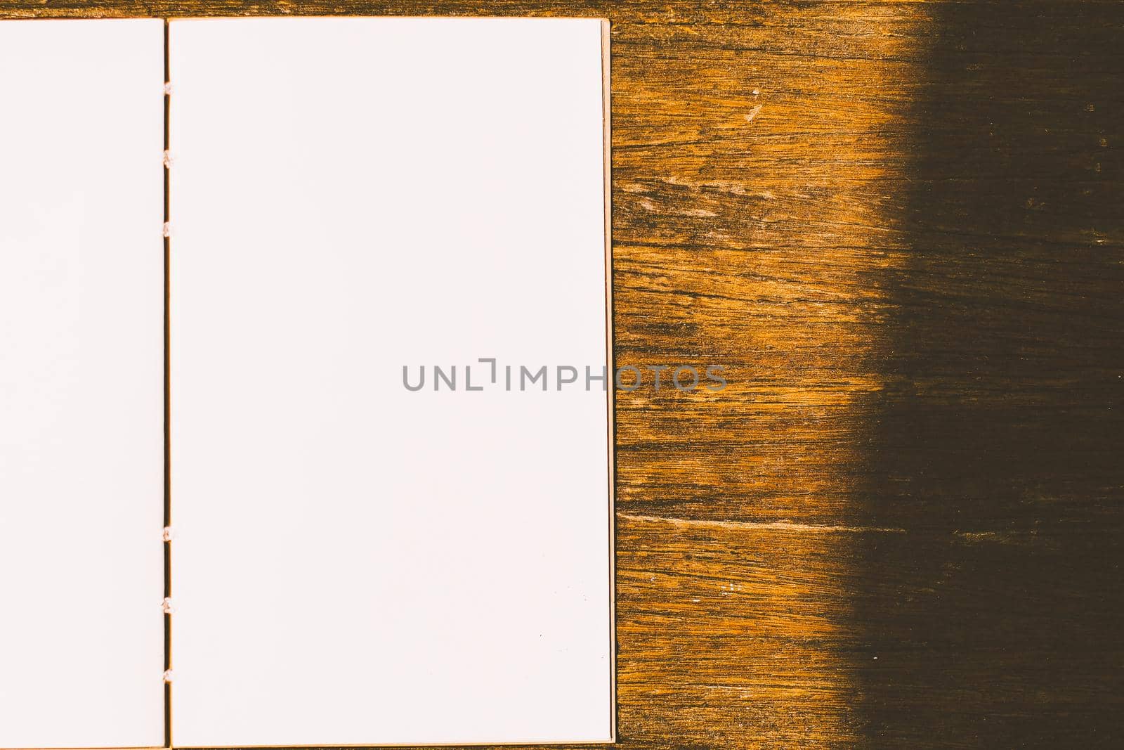 clean empty white note paper book on wood table background. by Petrichor